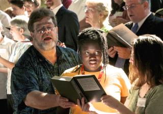 At Tennessee Valley Unitarian Universalist Church, Bill Dockery and his daughter, Haley, share a hymnal with Lea Alexander during the church’s rededication service, held one week after a shooting at the church in 2008.