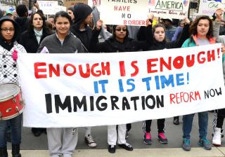 Protesters holding sign: "Enough is enough! It is time! Immigration reform now" at a Moral Monday rally in Raleigh NC, February 2014
