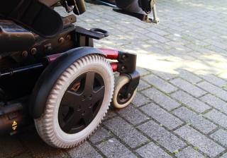 Side view of electric wheelchair on pavement