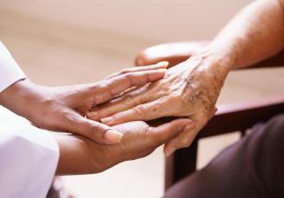 Senior Woman Talking With Black Doctor In Hospice - Stock image