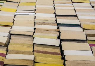 Stock photo of stacks of books on a bookshelf.