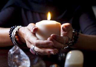 Hands holding a candle - Stock image