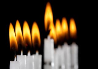 Lit candles from a Hanukkah menorah.