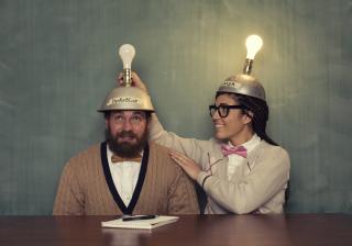 two people with hats with lightbulbs on top