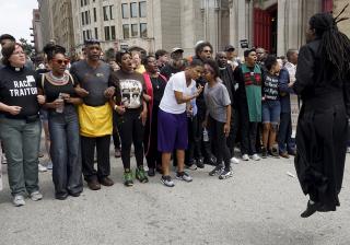 Ministers join protesters in march to St. Louis to mark the anniversary of Michael Brown’s death