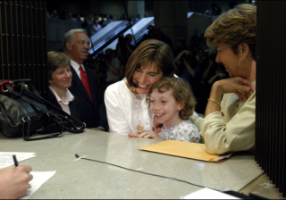 Julie and Hillary Goodridge, accompanied by their daughter, Annie, register to marry at Boston City Hall on May 17, 2004, as Mary Bonauto, their lawyer, and Mayor Thomas Menino look on.