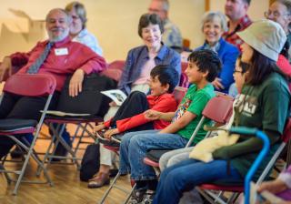 Nikesh Chacko Pandeya (in green) and his brother Devan (in red) actively engage with the Sunday service at Mission Peak Unitarian Universalist Congregation in Fremont, California.