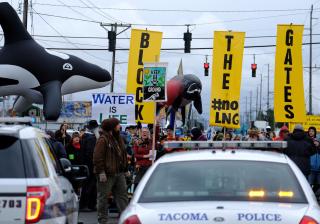activists close road and face police outside natural gas site near Tacoma, Washington