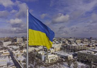 Stock photo of the Ukrainian Flag blowing in the wind over the city of Kharkov.