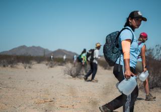 UUSC staff member Brittney Rose and others bring water to the desert of the Cabeza Prieta National Wildlife Refuge along the Arizona-Mexico border to leave for migrants making the dangerous journey to the United States.