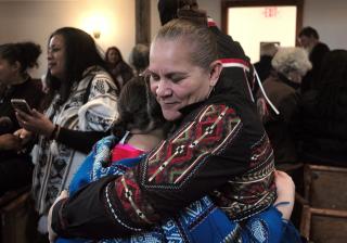 jessie little doe baird hugs an attendee at a November 2017 celebration at the Old Indian Meeting House in Mashpee, Massachusetts
