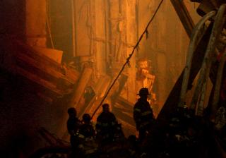 Rescue workers conduct search and rescue attempts, descending deep into the rubble of the World Trade Center, September 14, 2001