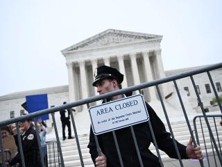 Police place a barricade in front of US Supreme Court. People protesting reversing of abortion rights