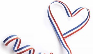 Red, white and blue heart shaped ribbon against white background