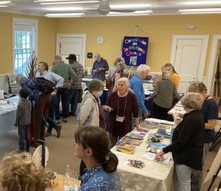 People visit vendor tables during the 2023 Democracy Festival held by First Parish in Concord, Massachusetts. The congregation is gearing up to host another one in June of this year.