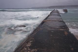 Concrete breakwater with waves 