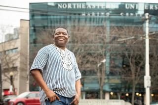Alfred Brownell stands in front of a Northeastern University building