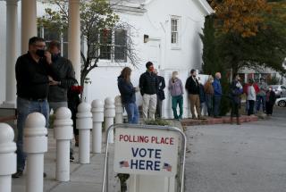 Voters wait in line before the polls open at All Souls Unitarian Church in Tulsa, Okla., Tuesday, Nov. 3, 2020