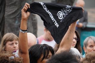 A protester holds a #BlackLivesMatter bandana at a rally in Portland, Oregon, June 28.