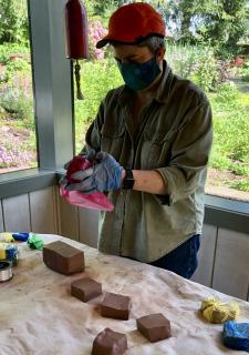 RK Young prepares clay for participants to pick up to create chalices during the pandemic spring 2020.