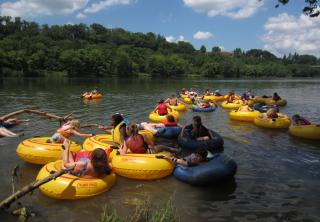 Children take to the river in inner tubes at SUUSI, the largest intergenerational gathering of Unitarian Universalists, in Virginia.