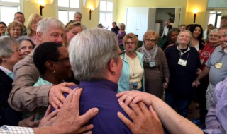 Members of the UU Congregation of the South Jersey Shore in Galloway, New Jersey, celebrate unanimously calling the Rev. Dawn Fortune as the congregation’s first settled minister in May 2017.