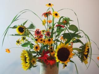a flower arrangement with summer flowers such as sunflowers