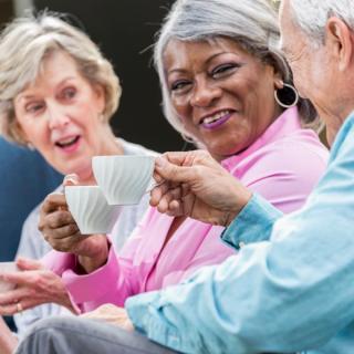 Older adults with coffee cups