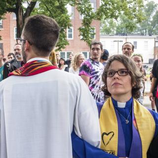 Interfaith clergy, including Unitarian Universalist Association President Susan Frederick-Gray (right), lock arms at Emancipation Park to protest the Unite the Right rally of white supremacists on August 12, 2017, in Charlottesville, Virginia.