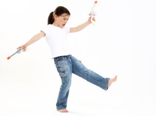 young girl plays with toy pistols