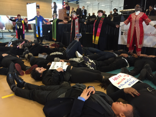 Twin Cities–area UU ministers join interfaith colleagues to form a prayer circle around young adults staging a Black Lives Matter die-in at Macalester College on Martin Luther King Jr. Day.