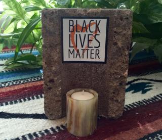 Black lives matter altar created using a cinder block that vandals threw into the Rev. Suzanne Redfern-Campbell's office window.