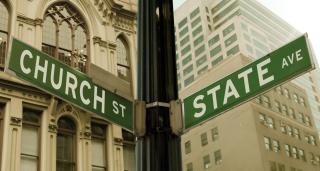 Photograph of two street signs, at the corner of Church St. and State Ave.