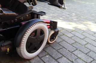 Side view of electric wheelchair on pavement