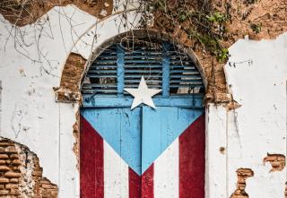 Arched doorway painted to resemble the flag of Puerto Rico