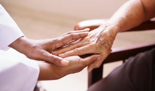 Senior Woman Talking With Black Doctor In Hospice - Stock image