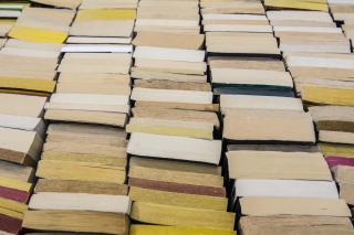 Stock photo of stacks of books on a bookshelf.