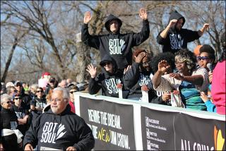 members of All Souls Unitarian Church in Tulsa march in the Martin Luther King, Jr. Day Parade in Tulsa wearing hoodies.