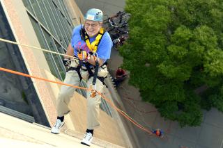 UUA President Peter Morales rappels down the Rhode Island Convention Center as part of the UUA's Brave Souls: UUs Pledge Over the Edge fundraiser. 