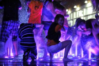Young UUs played in a fountain during Friday night's community celebration