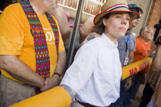 29 JULY 2010 - PHOENIX, AZ: Rev. Susan Frederick-Gray, from the Unitarian Universalist Church in Phoenix, waits to be arrested during a blockade of the 4th Ave Jail in Phoenix, AZ.