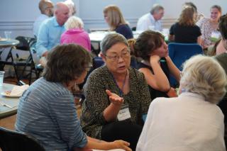 Conference-goers meet in small groups 