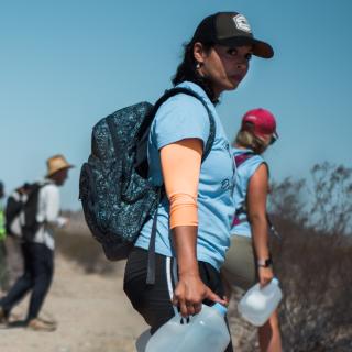 UUSC staff member Brittney Rose and others bring water to the desert of the Cabeza Prieta National Wildlife Refuge along the Arizona-Mexico border to leave for migrants making the dangerous journey to the United States.