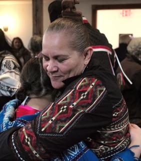 Close up:  jessie little doe baird hugs an attendee at a November 2017 celebration at the Old Indian Meeting House in Mashpee, Massachusetts. 