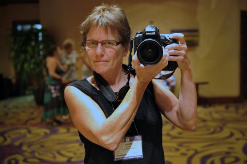 Photographer Nancy Pierce takes a picture of herself in front of a mirror