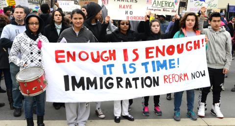 Protesters holding sign: "Enough is enough! It is time! Immigration reform now" at a Moral Monday rally in Raleigh NC, February 2014